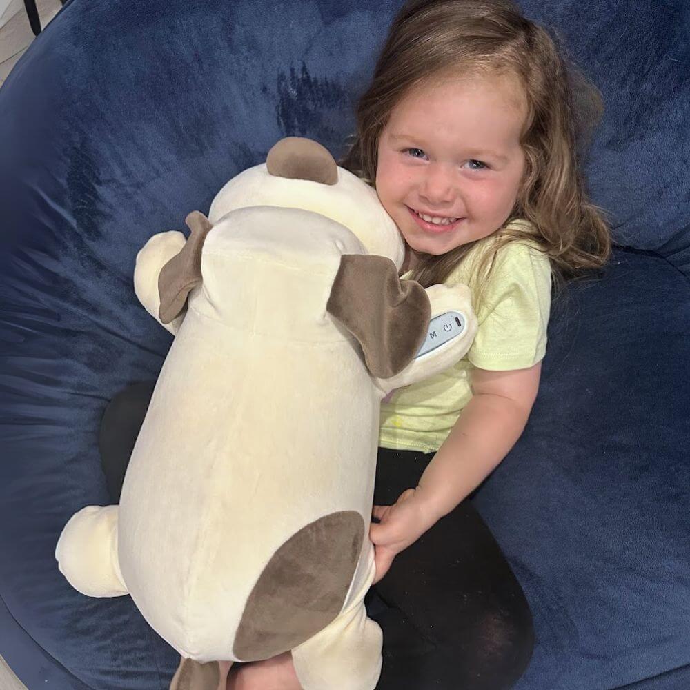 a child cuddling the bionic breathing smart pillow that was on sunrise in australia, she cuddles the dog as she gets ready for bed