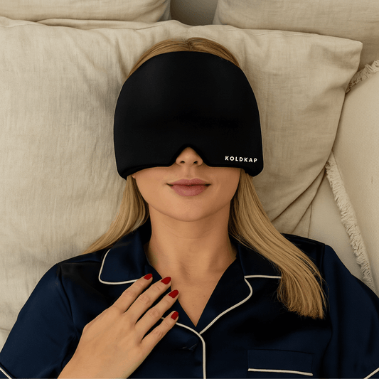 women relaxing wearing a migraine cap trying to get relief with a black ice mask
