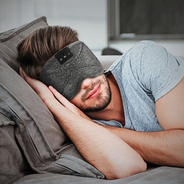 man wearing sleep headphones as a sleep aid during the day