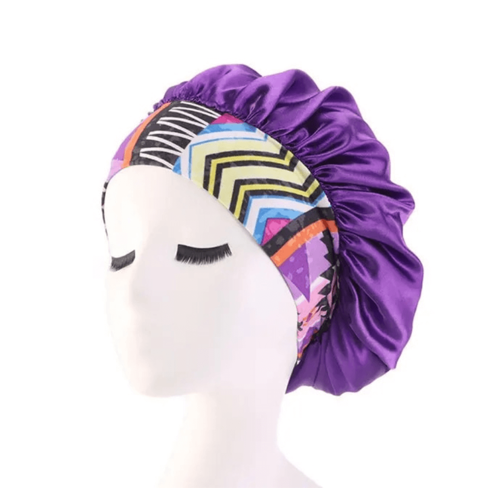 Purple aztec satin hair bonnet with printed band on a white background