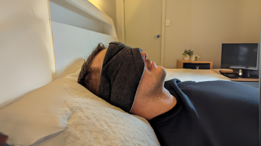 man with tinnitus using sleep headphones to stop the ringing