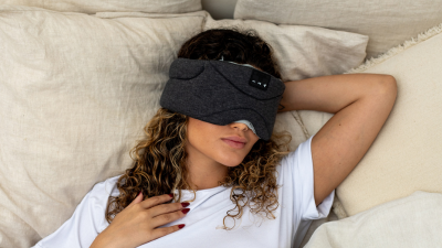 bluetooth headphones for sleeping women wearing black sleep mask to sleep