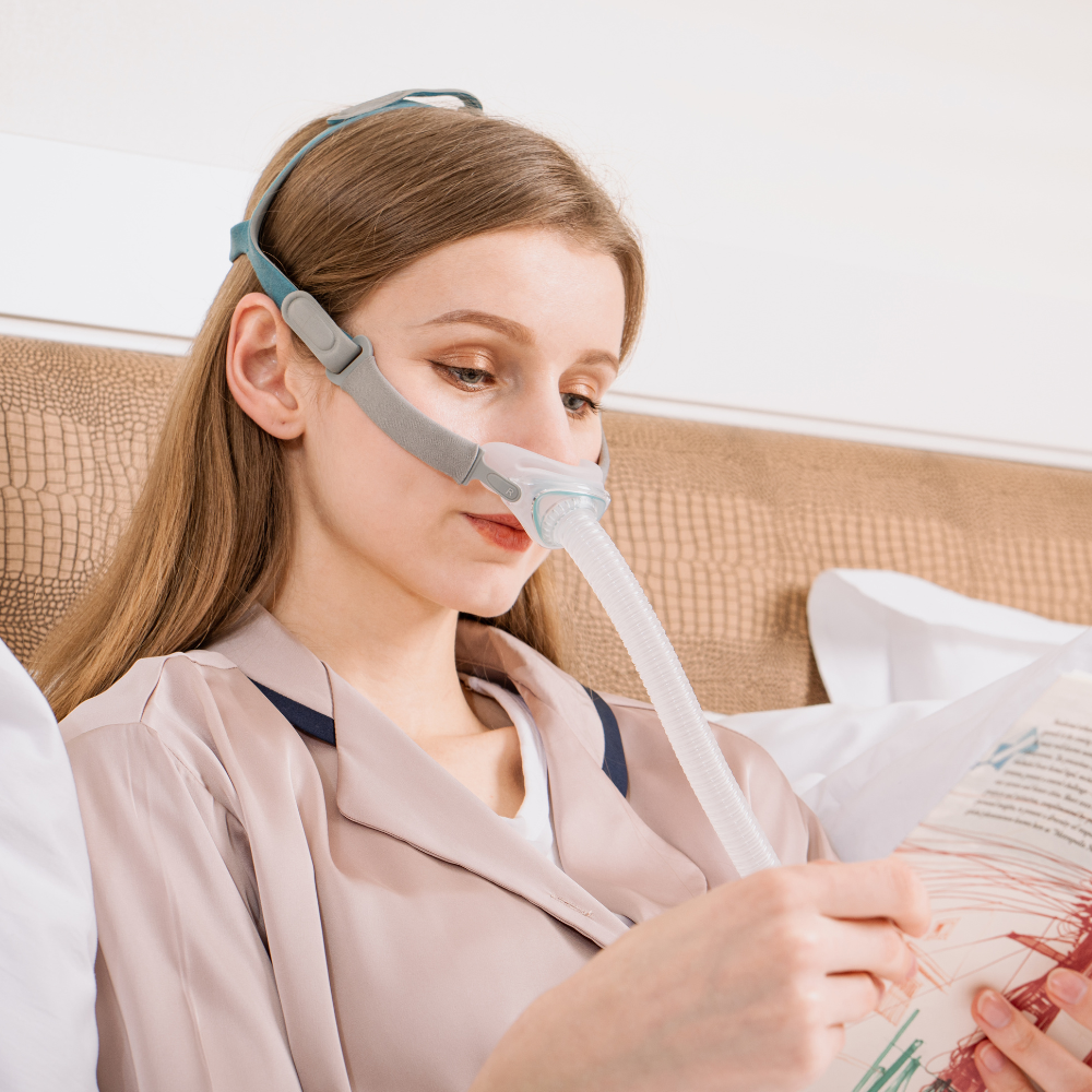 N6 CPAP Nasal Mask female in bed wearing the CPAP mask