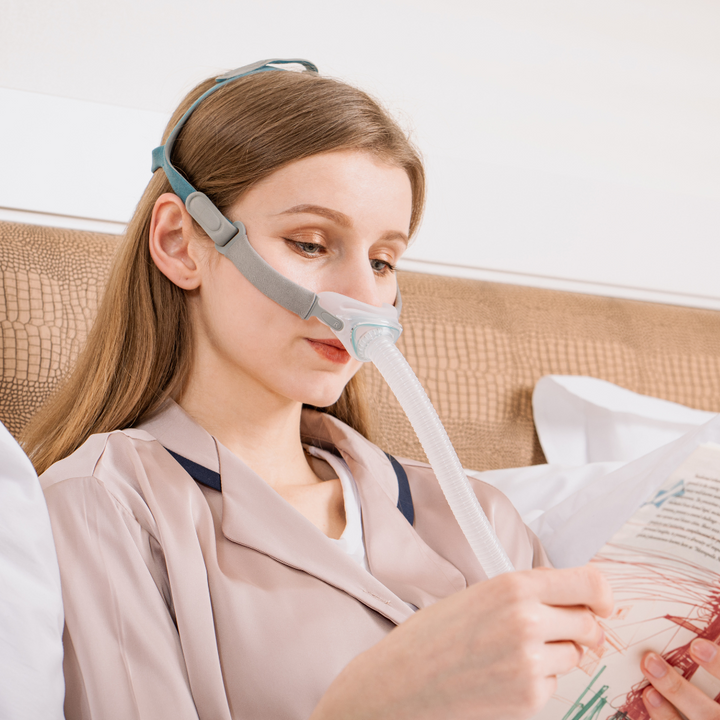 N6 CPAP Nasal Mask female in bed wearing the CPAP mask