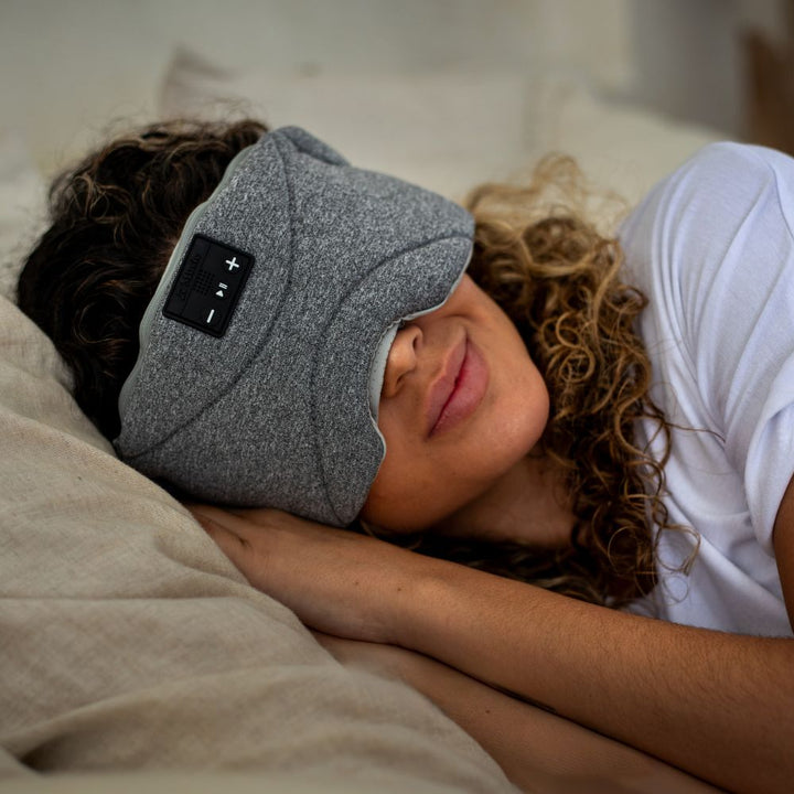 Women sleeping wearing sleep mask with headphones