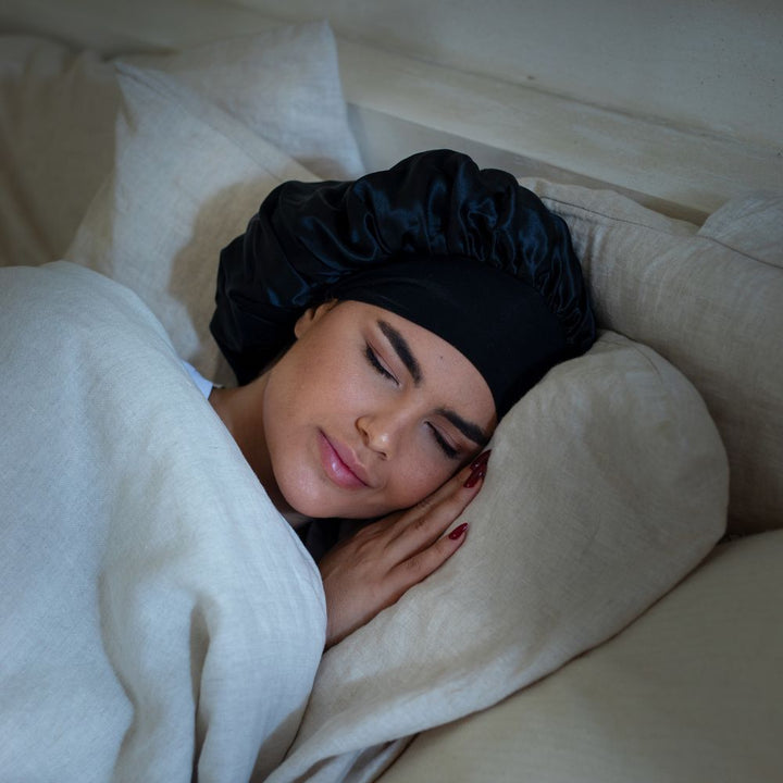 double layered black silk hair bonnet women asleep with cream sheets